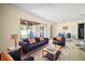 Bright living room with stylish blue sofa set, opening to a screened outdoor area at 2502 Tropical Shores Se Dr, St Petersburg, FL 33705