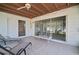 A covered patio with tile floor, sliding doors to the home, and outdoor furniture at 2502 Tropical Shores Se Dr, St Petersburg, FL 33705