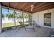 A covered patio offers lounging chairs and views of the fenced-in backyard at 2502 Tropical Shores Se Dr, St Petersburg, FL 33705