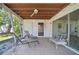 An outdoor patio space with tile flooring, lounge chairs, and a ceiling fan at 2502 Tropical Shores Se Dr, St Petersburg, FL 33705