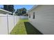 Side yard featuring a white fence and green grass at 2502 Tropical Shores Se Dr, St Petersburg, FL 33705