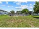 Home's backyard with green grass and landscaping at 2701 Camellia Ter, Punta Gorda, FL 33950