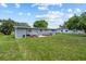 Home's backyard with green grass and landscaping at 2701 Camellia Ter, Punta Gorda, FL 33950