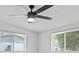 Bedroom with a ceiling fan and two windows showcasing a peaceful view at 2701 Camellia Ter, Punta Gorda, FL 33950