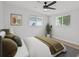 A bedroom with a ceiling fan, a picture on the wall and two windows with a tree outside at 2701 Camellia Ter, Punta Gorda, FL 33950