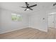 Bright bedroom features a ceiling fan, window, and closet with modern flooring throughout at 2701 Camellia Ter, Punta Gorda, FL 33950