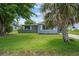 Charming single-story home with a well-manicured lawn, mature trees, and inviting curb appeal at 2701 Camellia Ter, Punta Gorda, FL 33950