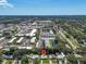 Beautiful aerial view of the property nestled in a vibrant neighborhood with nearby shopping centers and a scenic pond at 296 Huntington Dr, Largo, FL 33771