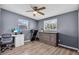 Bedroom with gray walls, laminate floors, and a ceiling fan with lighting at 296 Huntington Dr, Largo, FL 33771
