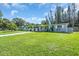 This property features a well-maintained lawn, mature trees, and a classic Florida single-story design at 296 Huntington Dr, Largo, FL 33771