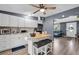 Inviting kitchen with island seating, stainless steel appliances, and seamless flow to living area at 296 Huntington Dr, Largo, FL 33771