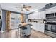 Bright kitchen with white cabinets, stainless steel appliances, and center island with seating at 296 Huntington Dr, Largo, FL 33771
