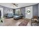 Cozy living room with a plush sofa, decorative rug, and ample natural light at 296 Huntington Dr, Largo, FL 33771
