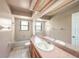 Bathroom with vanity, large mirror, and tiled shower/tub combination at 3009 Ainsworth Ave, Spring Hill, FL 34609