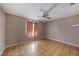 Cozy bedroom featuring parquet floors, a ceiling fan, and natural light at 3009 Ainsworth Ave, Spring Hill, FL 34609