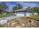 Single-story home with an attached garage, long driveway, and a storage shed at 3009 Ainsworth Ave, Spring Hill, FL 34609