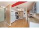Kitchen features white cabinets, laminate floors, and modern appliances at 3009 Ainsworth Ave, Spring Hill, FL 34609