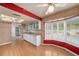 Bright kitchen with white cabinets, bay window, and adjacent dining area at 3009 Ainsworth Ave, Spring Hill, FL 34609