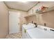 Laundry room with washer, dryer, and wire rack shelving at 3009 Ainsworth Ave, Spring Hill, FL 34609
