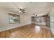 Spacious living room with parquet floors, built-in shelves, and natural light at 3009 Ainsworth Ave, Spring Hill, FL 34609