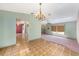 Open-concept living room with parquet flooring, carpet and views to other rooms at 3009 Ainsworth Ave, Spring Hill, FL 34609