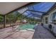 Screened-in pool with deck, partial view of exterior and shed at 3009 Ainsworth Ave, Spring Hill, FL 34609