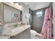 Modern bathroom features a large vanity, a decorative mirror, and a stylish tile shower with a floral curtain at 3127 W Sligh Ave # 101C, Tampa, FL 33614