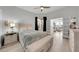 Comfortable bedroom with neutral decor, wood floors, and view into the living room at 3127 W Sligh Ave # 101C, Tampa, FL 33614