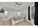 Cozy bedroom with a ceiling fan and a large window bringing in natural light at 3127 W Sligh Ave # 101C, Tampa, FL 33614