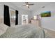 Bright bedroom featuring wood flooring, ceiling fan, and walk-in closet at 3127 W Sligh Ave # 101C, Tampa, FL 33614