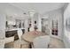 Bright dining room features neutral decor, a modern chandelier, and an open view into the stylish kitchen at 3127 W Sligh Ave # 101C, Tampa, FL 33614