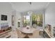 Bright dining area with modern chandelier, dining table, chairs, and a scenic outdoor view at 3127 W Sligh Ave # 101C, Tampa, FL 33614