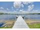 Wooden dock extending into the serene lake, providing access to water activities at 3127 W Sligh Ave # 101C, Tampa, FL 33614