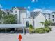 Charming condo complex with dedicated parking, lush landscaping, and picturesque walkway to the lake at 3127 W Sligh Ave # 101C, Tampa, FL 33614