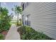 Charming condo exterior with lush landscaping and a sidewalk leading to the lake at 3127 W Sligh Ave # 101C, Tampa, FL 33614