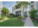Exterior of home with well-maintained lawn, carport, and walkway at 3127 W Sligh Ave # 101C, Tampa, FL 33614