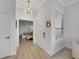 Hallway with neutral walls and floors with door leading to a bedroom, and a sunlit window at 3127 W Sligh Ave # 101C, Tampa, FL 33614