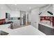 Bright kitchen featuring stainless steel appliances, white cabinetry, an adjacent laundry area, and a stylish wine rack at 3127 W Sligh Ave # 101C, Tampa, FL 33614