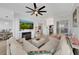 Open-concept living area featuring a modern fireplace, comfortable seating, and bright natural light at 3127 W Sligh Ave # 101C, Tampa, FL 33614