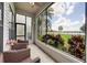 Comfortable screened porch with seating and serene views of the yard and water at 3127 W Sligh Ave # 101C, Tampa, FL 33614