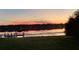 Scenic sunset reflecting on tranquil waters with a dock and lush green grass in the foreground at 3127 W Sligh Ave # 101C, Tampa, FL 33614