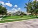View of the home's back exterior featuring a screened lanai and mature trees, creating a private backyard at 3503 Graycliff Ln, Brandon, FL 33511