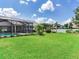 A well-maintained backyard features a screened pool, mature landscaping, and lush lawn at 3503 Graycliff Ln, Brandon, FL 33511