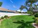 A lovely backyard features a lush lawn, a privacy fence, and mature landscaping at 3503 Graycliff Ln, Brandon, FL 33511