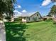 Expansive backyard featuring lush green lawn and screened lanai, perfect for outdoor entertaining at 3503 Graycliff Ln, Brandon, FL 33511