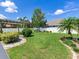 Manicured backyard with green lawn, pergola, stone pathway and lush landscaping at 3503 Graycliff Ln, Brandon, FL 33511