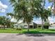 Lush backyard with mature trees surrounding a single-Gathering home with a screened-in lanai at 3503 Graycliff Ln, Brandon, FL 33511