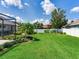 The property boasts a spacious backyard with a lawn, landscaping, and a screened pool at 3503 Graycliff Ln, Brandon, FL 33511