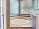 Bright bathroom featuring a jacuzzi tub surrounded by tile and a shower at 3503 Graycliff Ln, Brandon, FL 33511