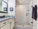 Well-lit bathroom featuring white subway tile, a framed glass shower, and granite countertop at 3503 Graycliff Ln, Brandon, FL 33511